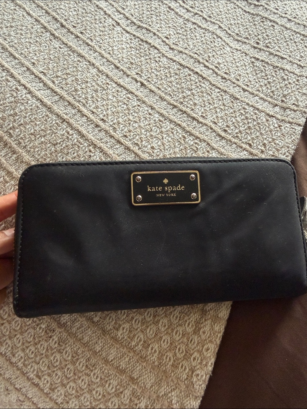 kate spade black nylon zip-around wallet with gold logo plate
